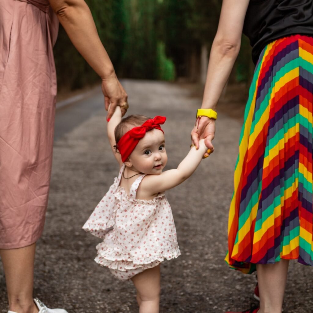 a baby with red bow tie holding her fringe